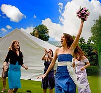 The throwing of the bouquet and being caught by thrilled wedding guest.